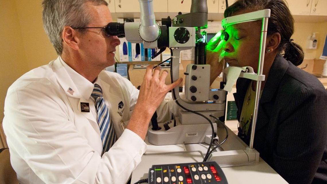 Dr. William Smiddy performs a pan-retinal photocoagulation on Allapattah resident Erica Powell at Bascom Palmer Eye Institute, part of the University of Miami medical school. The laser procedure is one of the treatments available for diseases of the eye caused by diabetes.