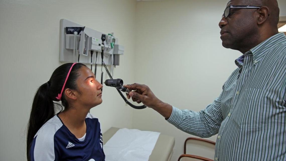 Evelyn Roque, then a 15-year-old 10th grade soccer player at American Senior High, is examined in 2015 by UM neurologist Kester Nedd to determine whether she can return to play after a concussion.