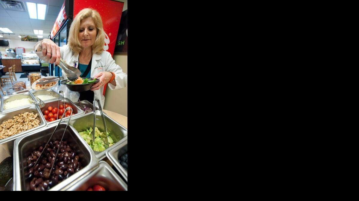 
ANTI-INFLAMMATORY DIET: Lesley Klein, a dietitian with the Sylvester Comprehensive Cancer Center at the University of Miami Miller School of Medicine, prepares a salad at the medical center in Allapattah.
