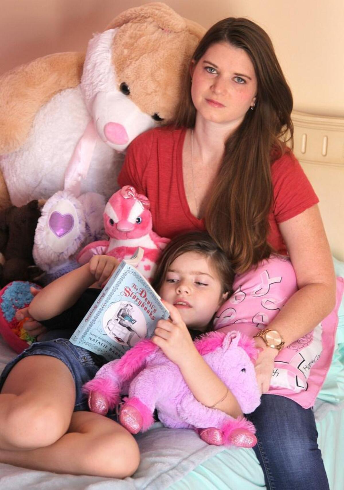 Valerie Bunt, 33, a young breast cancer survivor poses with her daughter, Alyssa, 8.