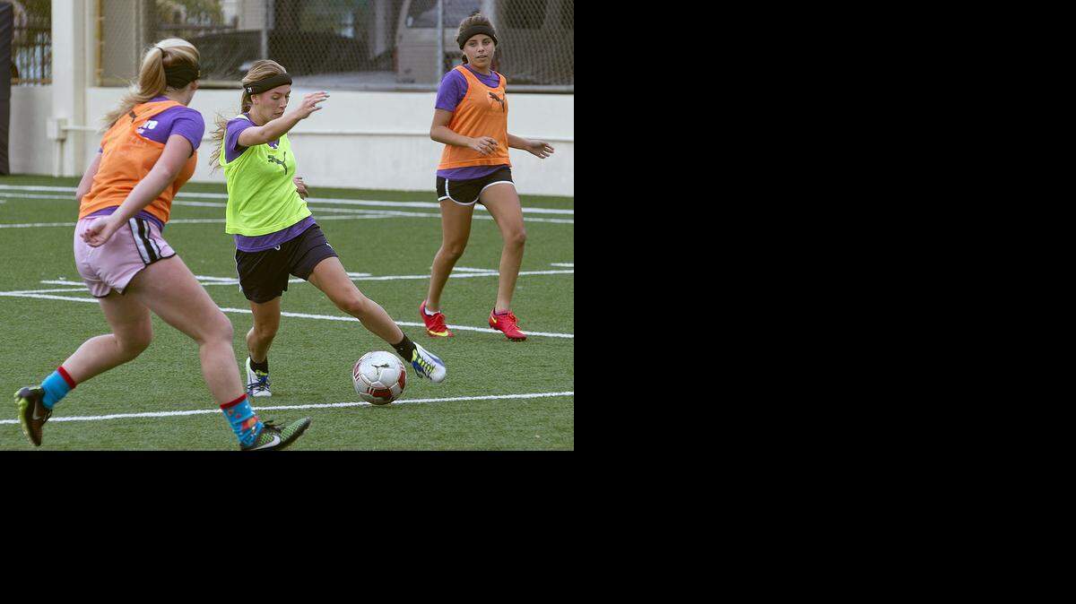 
EYE ON SAFETY: St. Thomas Aquinas girls soccer player Francesca Larraine, center, and teammates wear protective headbands while practicing Nov. 20 at the Fort Lauderdale school. Fellow players, below from left, Isabella Dorosy, Sofia Julien and Dallas Dorosy model the headgear that may help prevent concussions.


