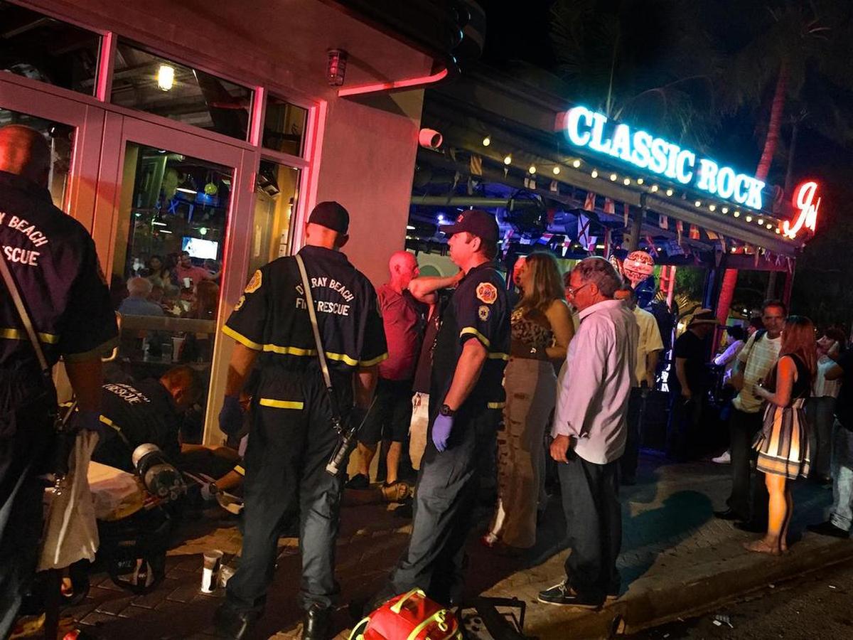 Delray Beach Fire Rescue firefighter-paramedics help a woman experiencing a dizzy spell in downtown Delray Beach on May 19, 2017.