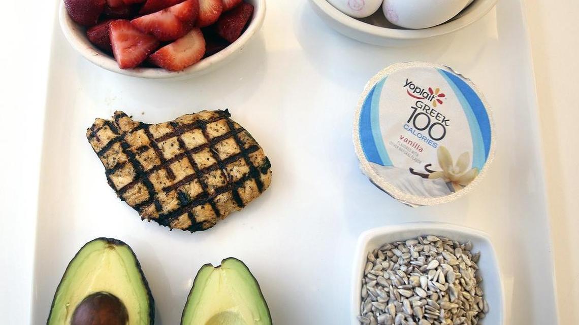 This plate of healthy foods recommended for women contains, clockwise from upper left, strawberries, eggs, yogurt, plain sunflower seeds, an avocado and a grilled chicken breast. Gina Sweat, a registered dietitian at Cleveland Clinic Florida, says women's nutritional needs change as they age. The foods were photographed Friday, June 17, 2016, in the cafeteria at Cleveland Clinic Florida, 2950 Cleveland Clinic Blvd., Weston.