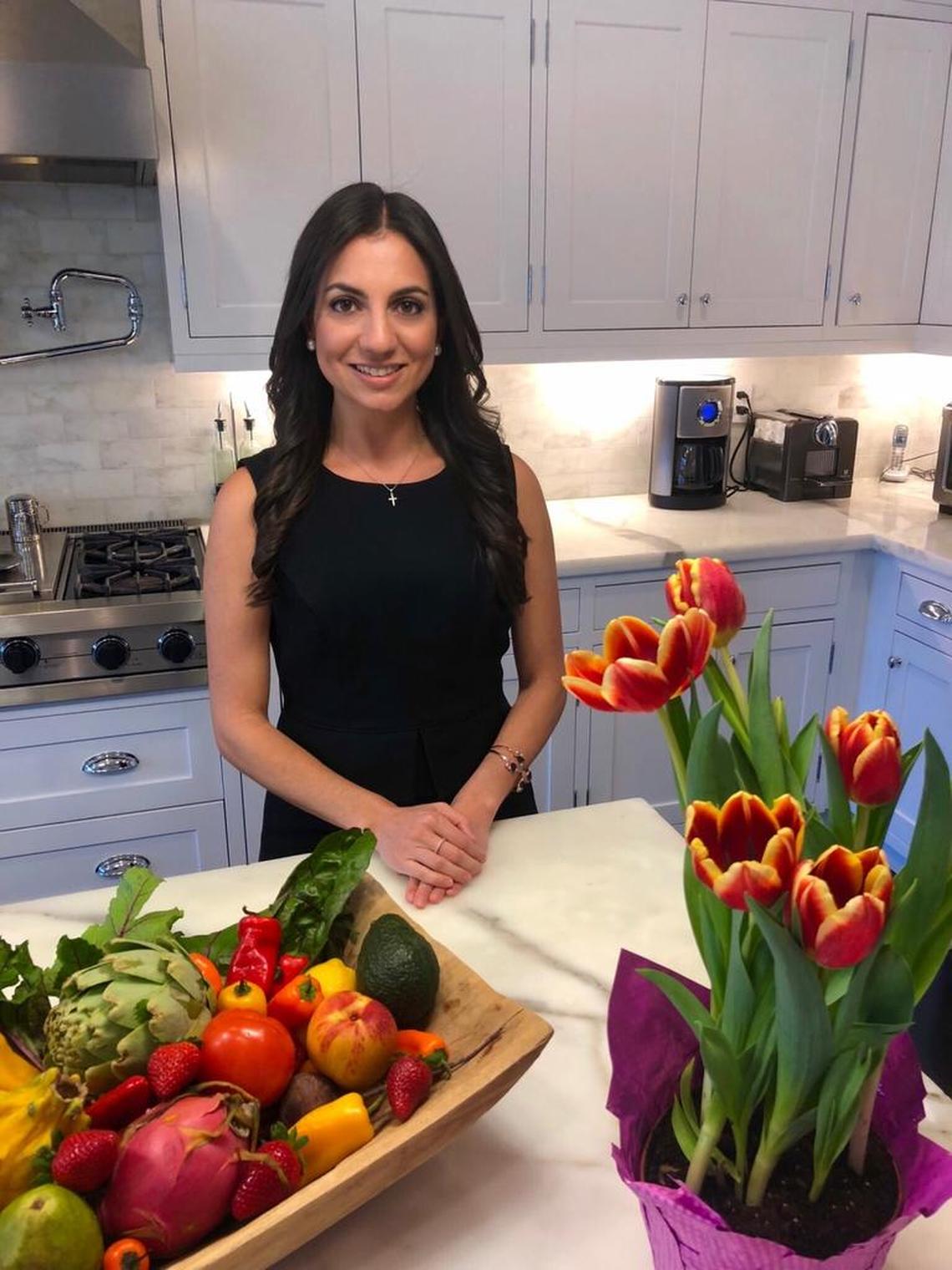 Lucette Talamas, a registered dietitian with Baptist Health South Florida, with healthy fruits and vegetables.