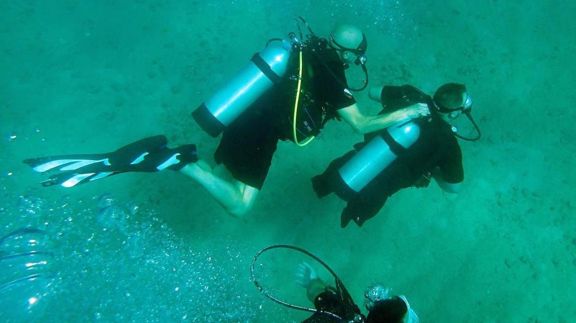 Jim Elliott, left, president of Diveheart, dives with Joseph Deslauriers 36, a wounded Air Force retired vet, off the Fort Lauderdale coast. They’re checking on coral with Nova Southeastern University College of Natural Sciences and Oceanography, and DiveBar, Wednesday June 24, 2015. Joseph lost one arm and both legs in a land mine explosion.