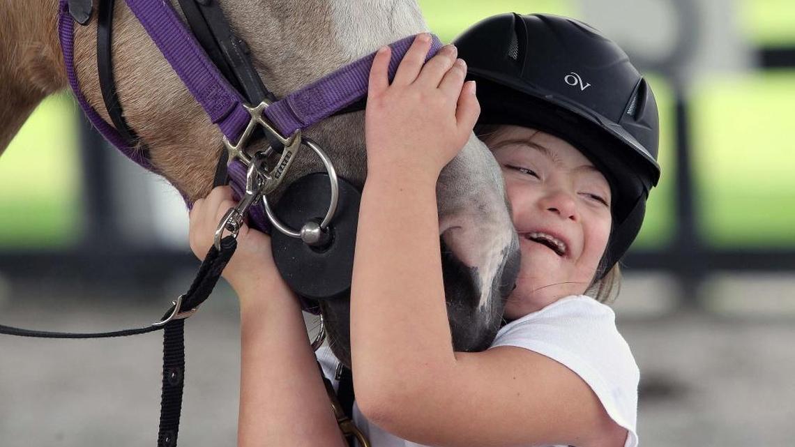 Camila Cardenas hugs Cinnamon at Whispering Manes Therapeutic Riding Center barn facility in Miami-Dade County’s horse country on Wednesday, Oct. 26, 2016. Whispering Manes serves adults and children with special needs, women victims of domestic violence, and veterans with PTSD.