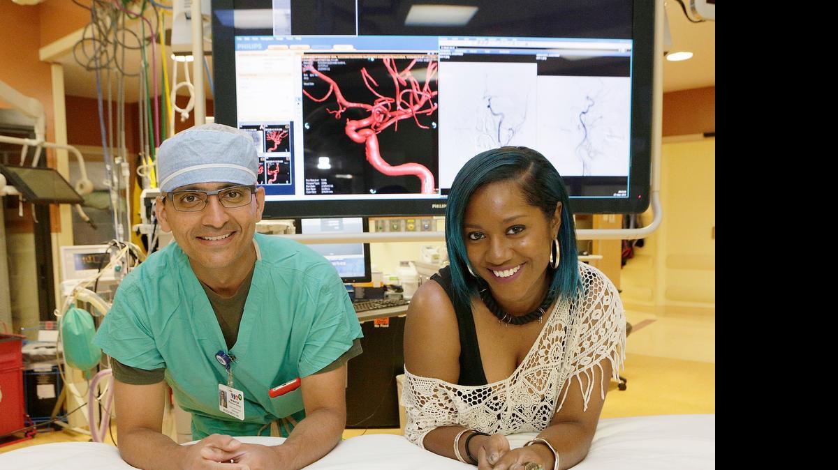 
STROKE SURVIVOR: Latoya Roberts, 26, visits her doctor, neurointerventional surgeon Brijesh Mehta, at Memorial Hospital West.  She suffered strokes, had surgery and recovered.
