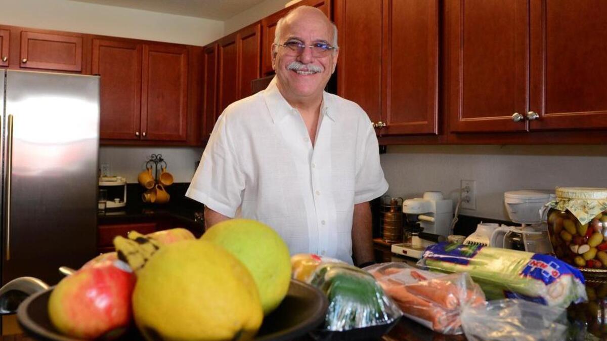 Homero Lavernia, 63, in his kitchen in Doral. Lavernia has been seeing a UM nutritionist for about three months.