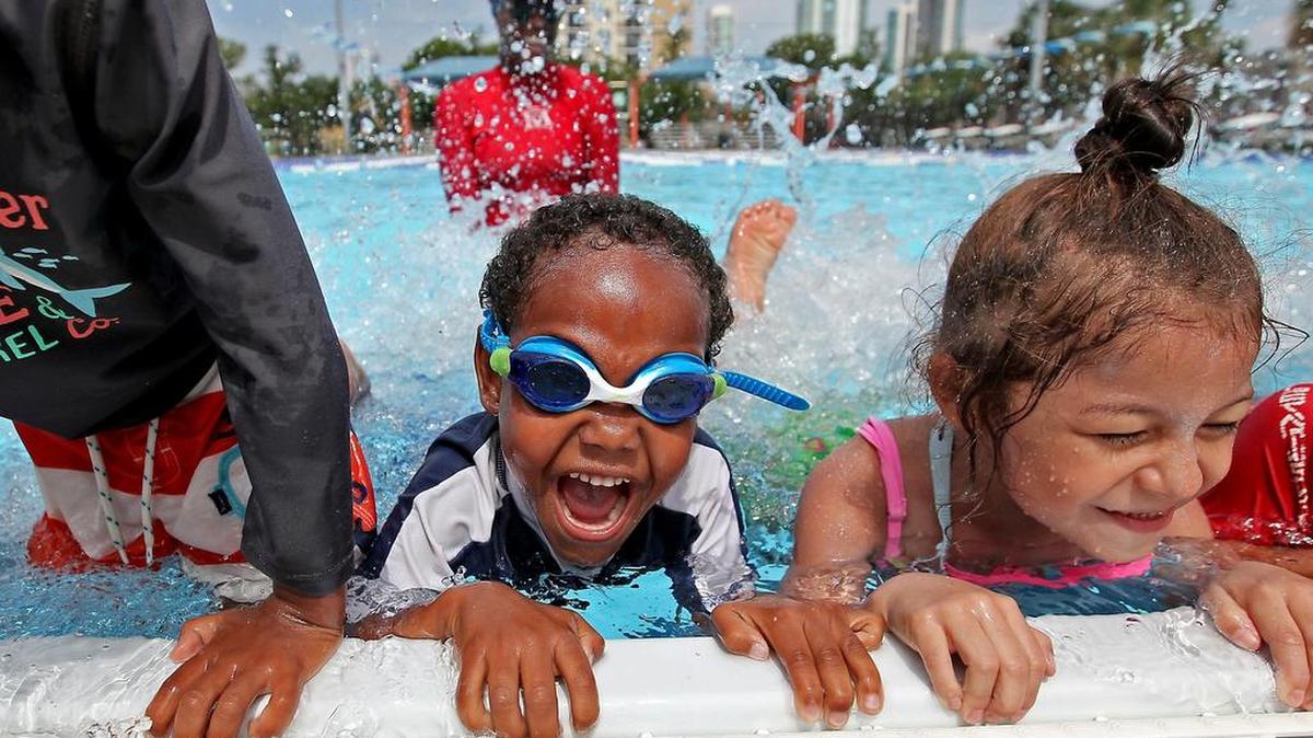 Danny Richardson, 6, left, and Jade Gamarra 5, enjoy their lessons at the summer swim program at Gibson Park pool. The Biscayne Bay Kiwanis Club has underwritten 24 free swimming lessons for 50 children.