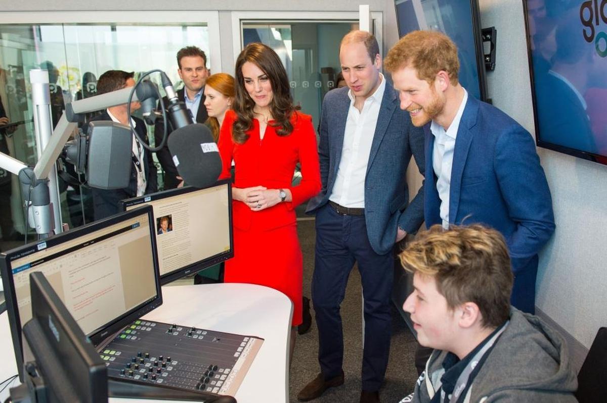 Britain's Catherine, Duchess of Cambridge, Britain's Prince William, Duke of Cambridge, and Britain's Prince Harry tour a radio studio during the official opening of the Global Academy in Hayes, London on April 20, 2017, in support of the Heads Together campaign.