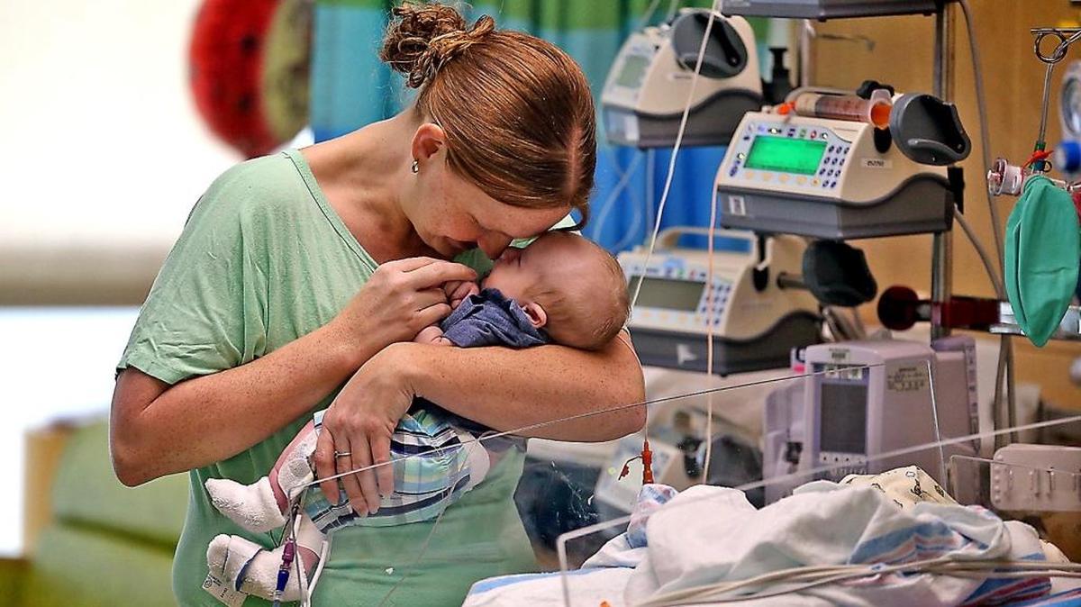 Sarah Lemons cradles her baby, Calvin Taylor, on Thursday, Aug. 10, 2017. Calvin received life-saving heart surgery at Nicklaus Children’s Hospital by Dr. Redmond P. Burke after being deemed inoperable by four high-risk congenital heart transfer hospitals.