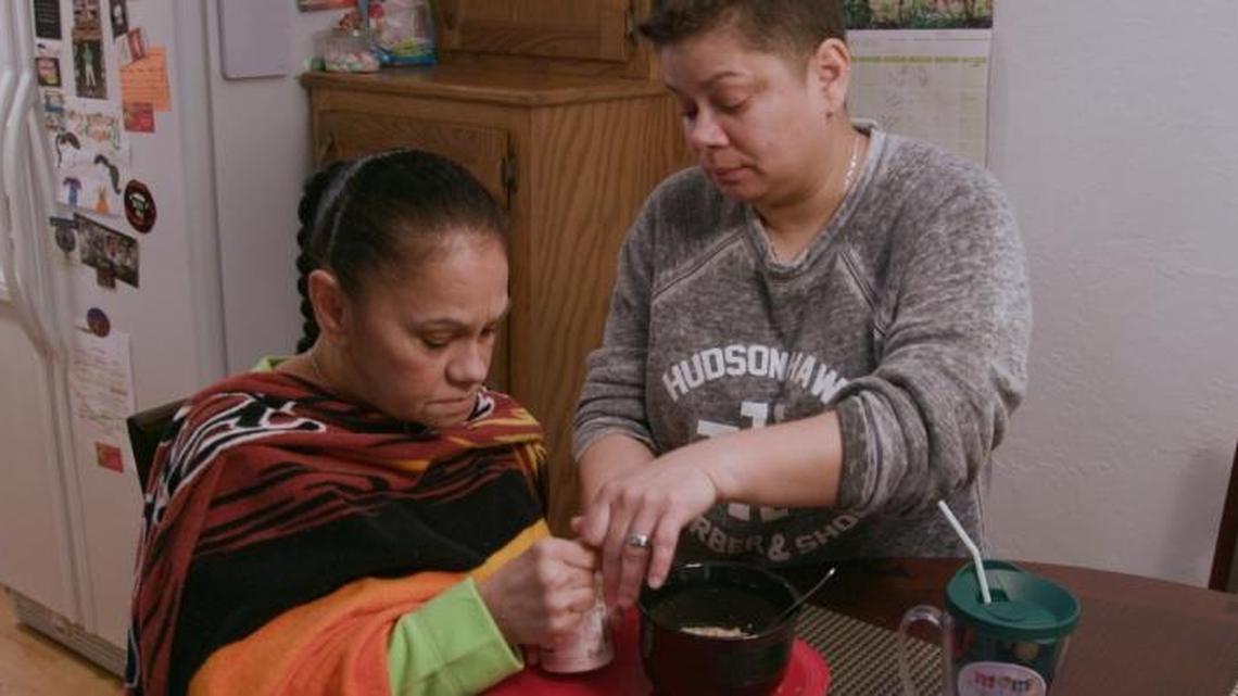Daisy Duarte, one of the caregivers featured in a PBS documentary, takes care of her mother, Sonja, as she struggles with the effects of Alzheimer's disease.