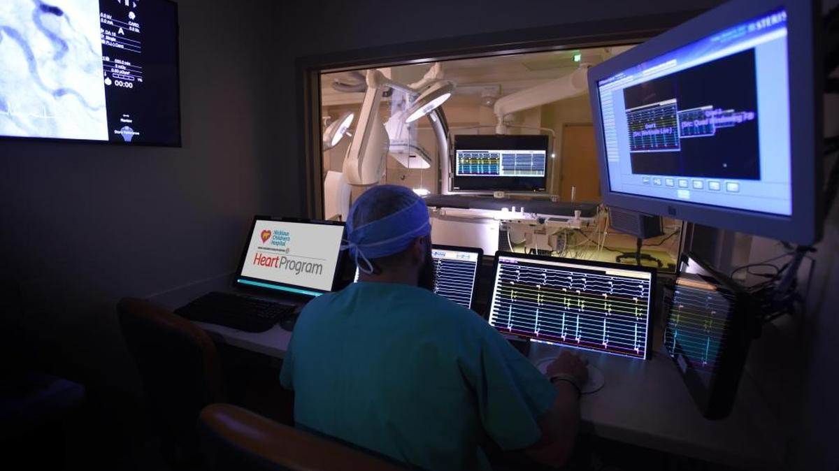 Matthew Clements, supervisor of catheterization laboratory operations at Nicklaus Children’s Hospital, prepares the lab for a procedure.