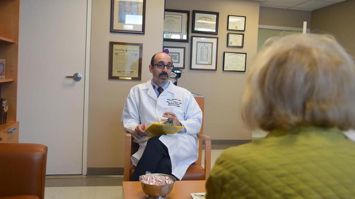 Dr. Marc Agronin, founding director of the memory center and Alzheimer’s clinical research program at Miami Jewish Health, consults with a patient enrolled in an Alzheimer’s clinical trial.