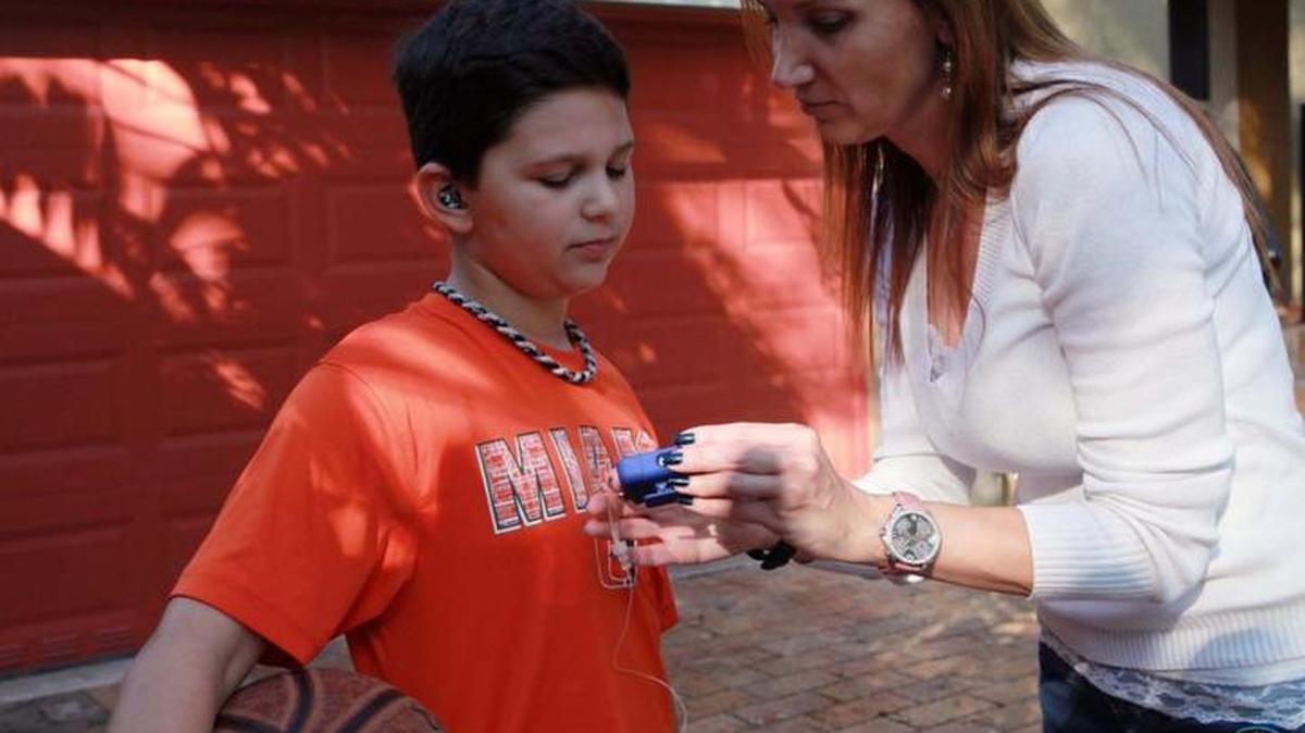 Colby Ferris, 11, who plays basketball and baseball, with his mother, Sabrina Gallo. She frequently checks his glucose monitor; he was diagnosed with diabetes type 1 at age 4.