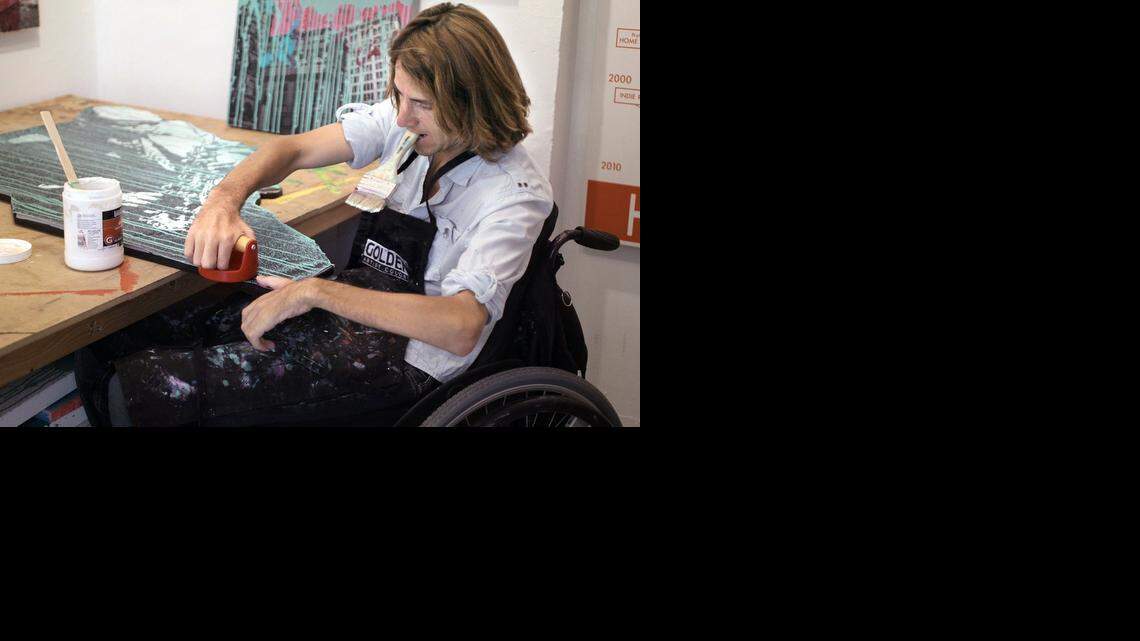 
David McCauley, a mixed-media artist and the founder of Rise Up Gallery, smooths the edge of one of his new artworks at ArtCenter / South Florida in Miami Beach.  Rise Up Gallery is a nonprofit organization that provides free art therapy workshops to the community and a venue in which emerging artists can exhibit their work. McCauley sustained a spinal cord injury in 2008 while diving; he is among nearly 35 resident artists at ArtCenter in South Beach. He also partners with Jackson Rehabilitation Hospital to provide free art therapy workshops to inpatients and outpatients who have spinal cord injuries.
