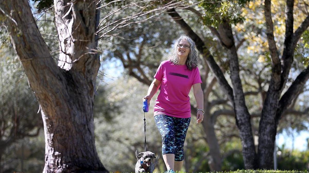 Mila Veledar, 61, walks her dog Pasha near her Miami home. Veledar learned she had high cholesterol 10 years ago. She started taking statins, which reduced her cholesterol, but raised her liver enzymes. In 2014, she underwent a coronary calcium scan, which looks for calcium deposits in the arteries, and is a predictor of heart disease. Because she had no calcium deposits, her doctor took her off statins.
