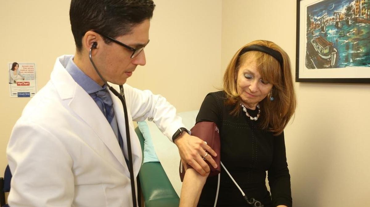 Roslyn Sand is examined by Dr. Juan-Carlos C. Brenes, a board-certified cardiologist and internist at Mount Sinai Medical Center in Miami Beach, on Feb. 8, 2018.