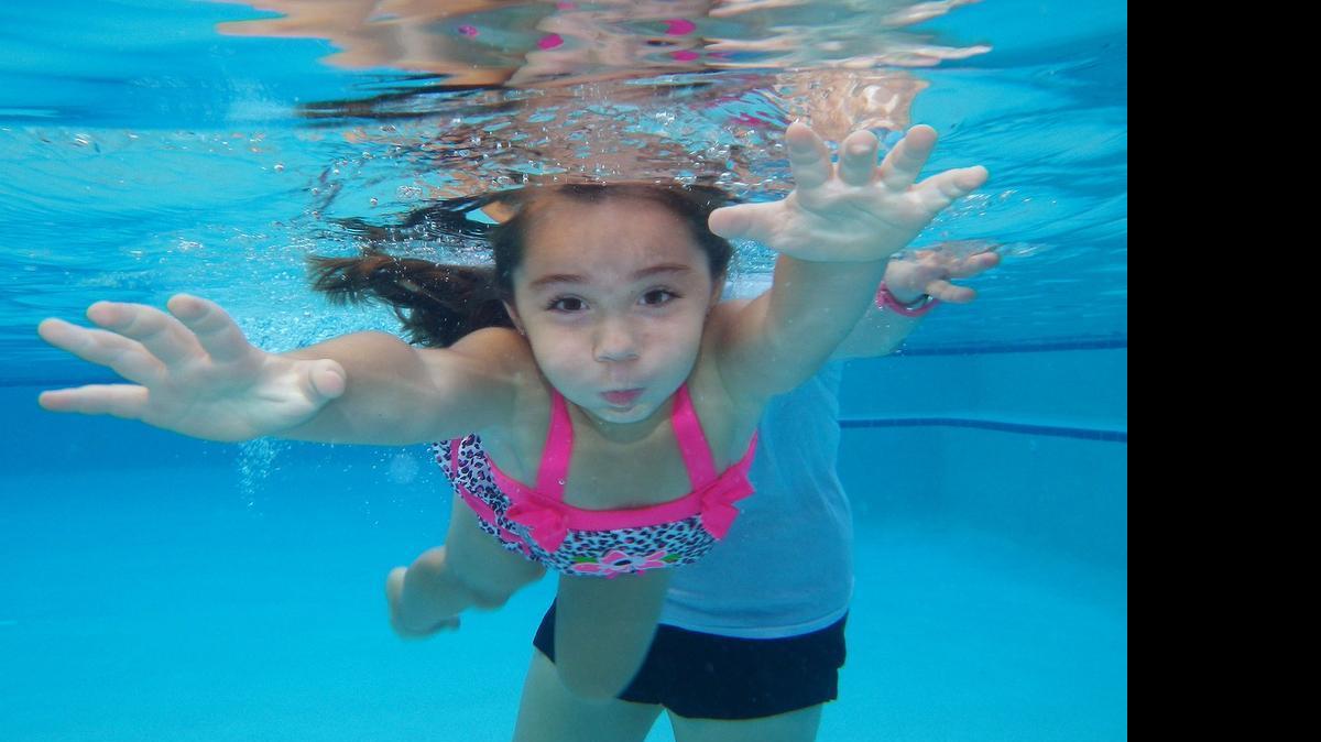
Reaching out: Maria Malito, 4, swims toward the side of the pool during a Baby Otter Swim School lesson in Plantation.
