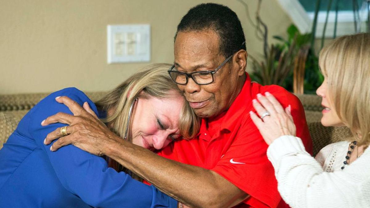 Mary Reuland listens to the heart of her son, Konrad, who died in December, transplanted into former MLB baseball player Rod Carew.