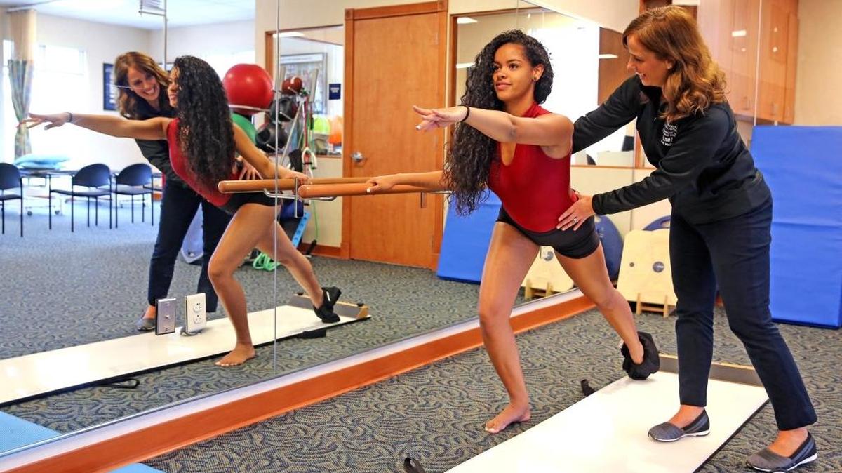 Whitney Chambers, a physical therapist, treats dancer Victoria Moraga, 16, at Joe DiMaggio Children's Hospital in Coral Springs on July 11, 2017.