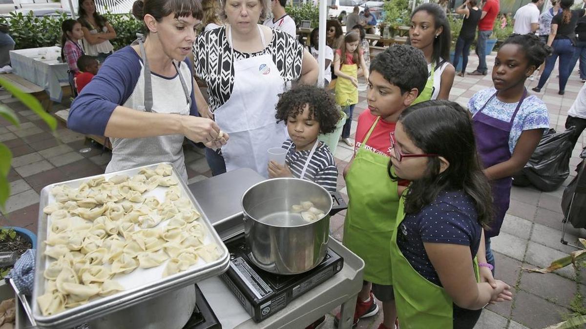 Mimi Chaein, owner of The Skills Culinary & Kitchen, teaches kids how to cook dumplings during a hands-on kitchen and cooking skills workshop for kids at The Wynwood Yard on Saturday, March 5, 2016.