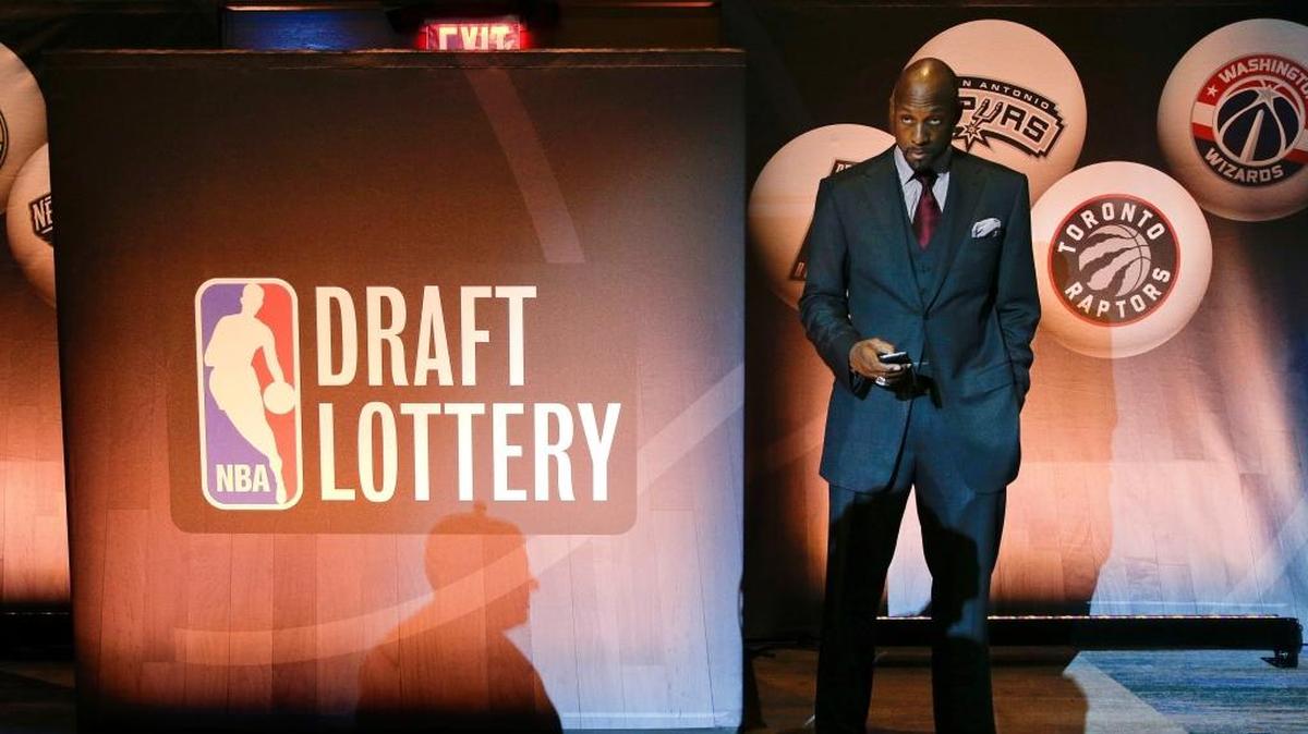 Miami Heat vice president Alonzo Mourning checks his cell phone before NBA basketball draft lottery in May of 2015. The Heat will participate in the May 14 lottery for the second time in three years.