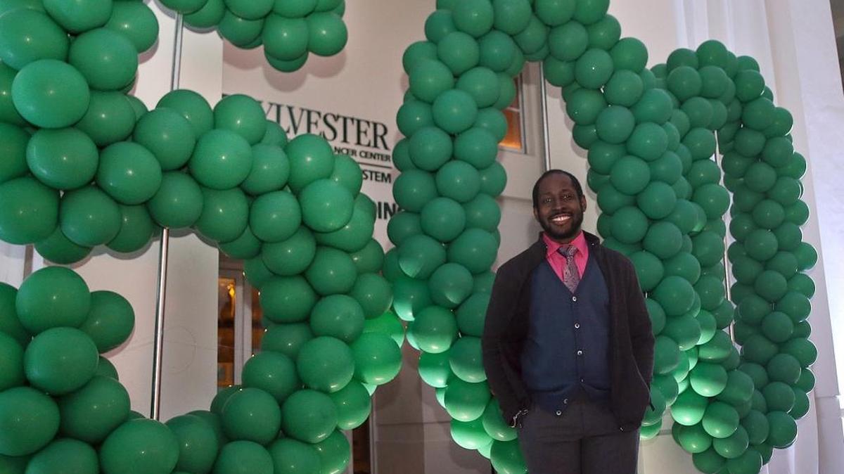 Keith Oliver, patient 500 to received a stem cell transplant for a Hodgkins lymphoma on September 2015, posed next to a 500 balloons display during an event to celebrate the 500th stem cell transplant to treat cancer patients at Sylvester Comprehensive Cancer Center in Miami, on January 14, 2016.