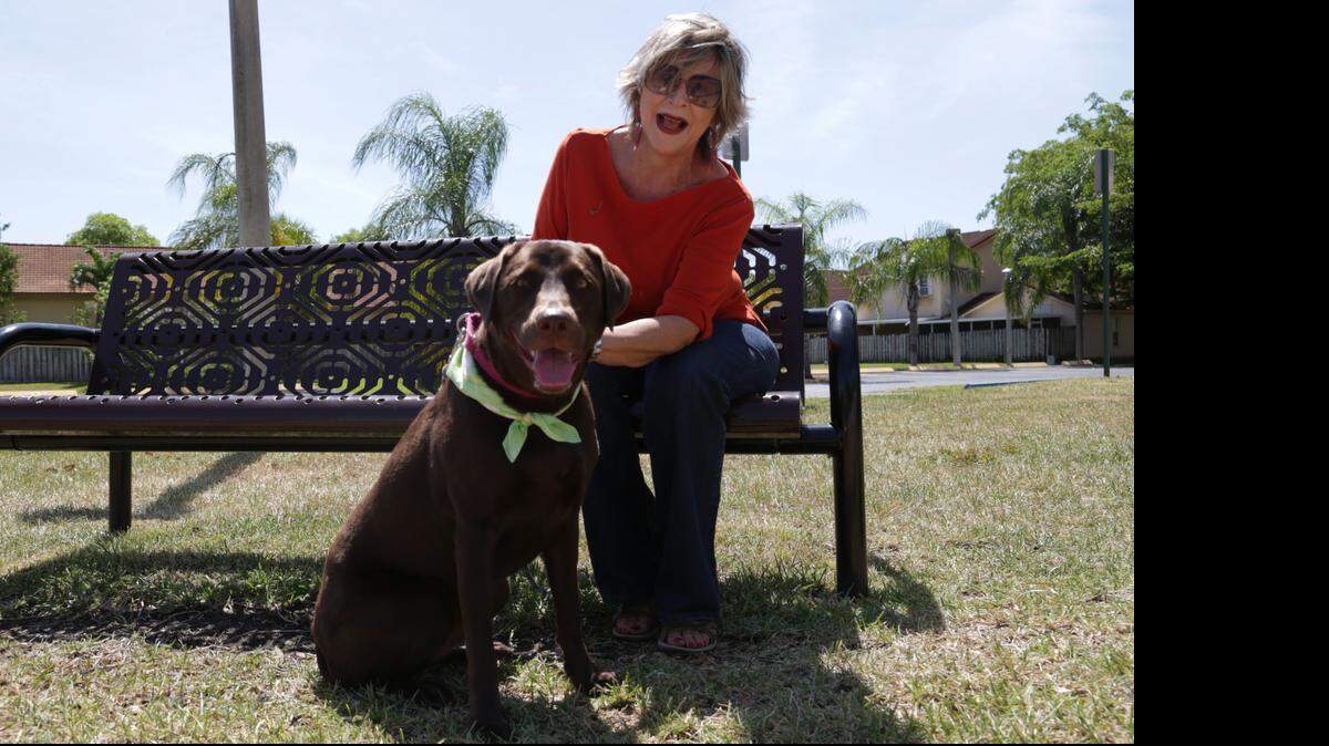 
Aurora Trajkovic, 66, plays with her dog in a park in Cutler Bay. Trajkovic fractured her femur when stepping out of a motor home three months ago. She underwent hip replacement surgery at West Kendall Baptist Hospital. After about a month of using a walker and never missing physical therapy, she fully recovered and is back to gardening, cleaning her house and playing with her labrador retriever, Pancha. 
