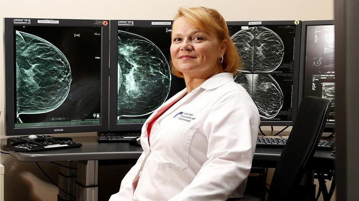 EARLIER DETECTION:  Dr. Mary Hayes-Macaluso, medical director of Women’s Imaging at Memorial Healthcare System in Miramar, sits near screens showing 3-D mammography technology. With the 3-D technology, ‘cancers get diagnosed earlier that would otherwise go undetected for years,’ she said.