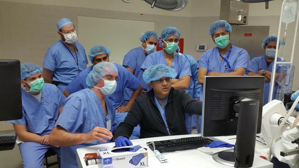In this 2016 file photo, Dr. Dipen Parekh, center, the chair of the department of urology at UM’s medical school shows his colleagues the process of focal therapy on his computer screen.