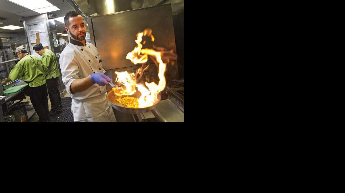 
Chef Richard Plasencia is executive chef for Baptist Health. Here he works on a healthier version of a pork loin dish he prepared in his main kitchen at South Miami Hospital.

