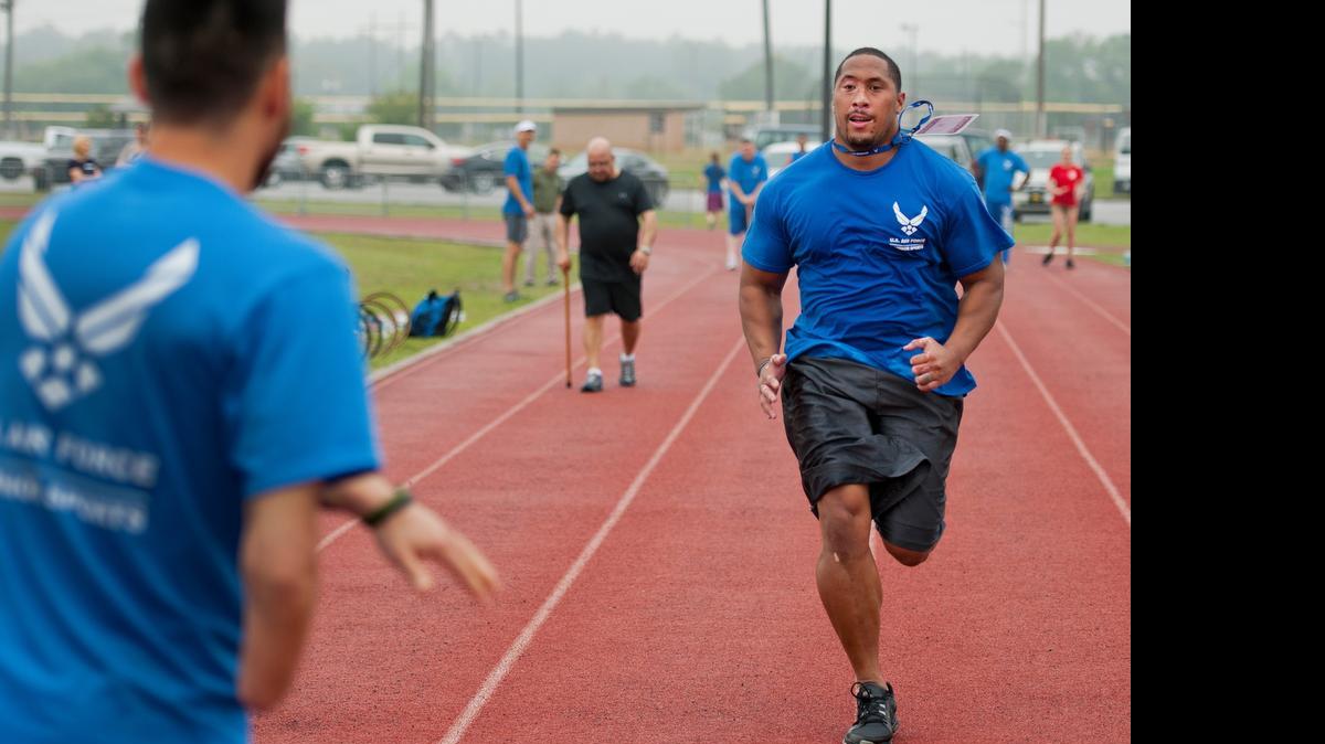
Tino Uli sprints to tag his partner at an introductory adaptive sports and rehabilitation camp at Eglin Air Force Base near Valparaiso on April 14. Airmen gathered in the Florida Panhandle for a training camp hoping to defeat the Army, Marines and Navy next month at the 2015 Department of Defense Wounded Warrior Games in Quantico, Virginia. 
