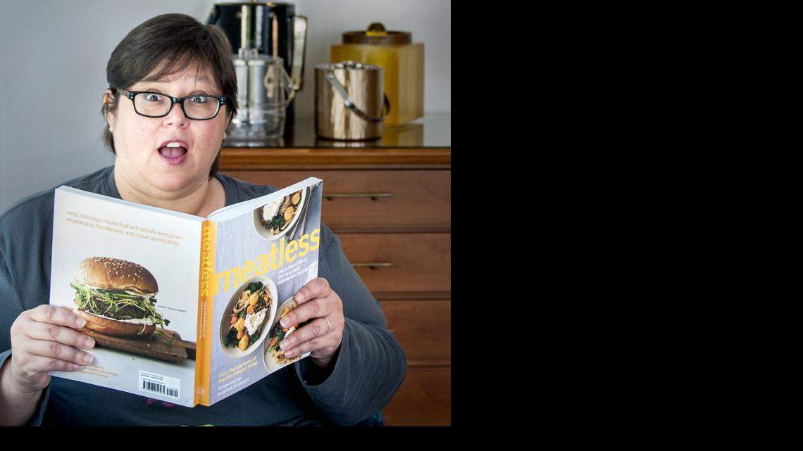 
HEALTHIER DIET: Alison Burgos, resident of Miami Shores, reads through a vegetarian cookbook. Burgos lost 60 pounds following a vegan diet. 


