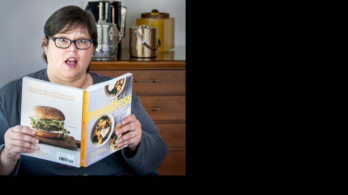 
HEALTHIER DIET: Alison Burgos, resident of Miami Shores, reads through a vegetarian cookbook. Burgos lost 60 pounds following a vegan diet. 


