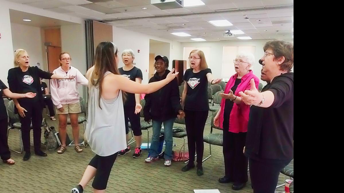 
Heroines Choir's musical director Analy Mendez leads a rehearsal for the event Arts for Healing on a recent Saturday.
