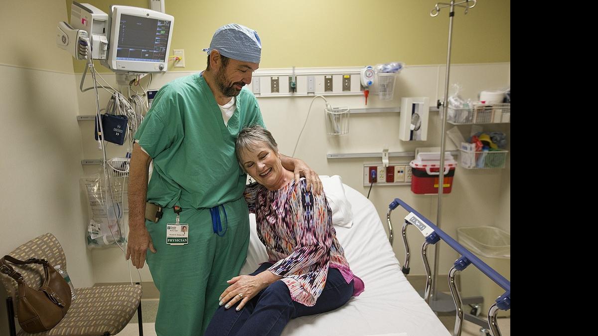 
Dr. Ricardo Estape, meets with his patient, Mrs. Nilda Acosta, at South Miami Hospital on Monday, May 11, 2015, to discuss her treatment for ovarian cancer. He has used a type of chemo that had been used for appendix, but now is also being used for ovarian cancer.
