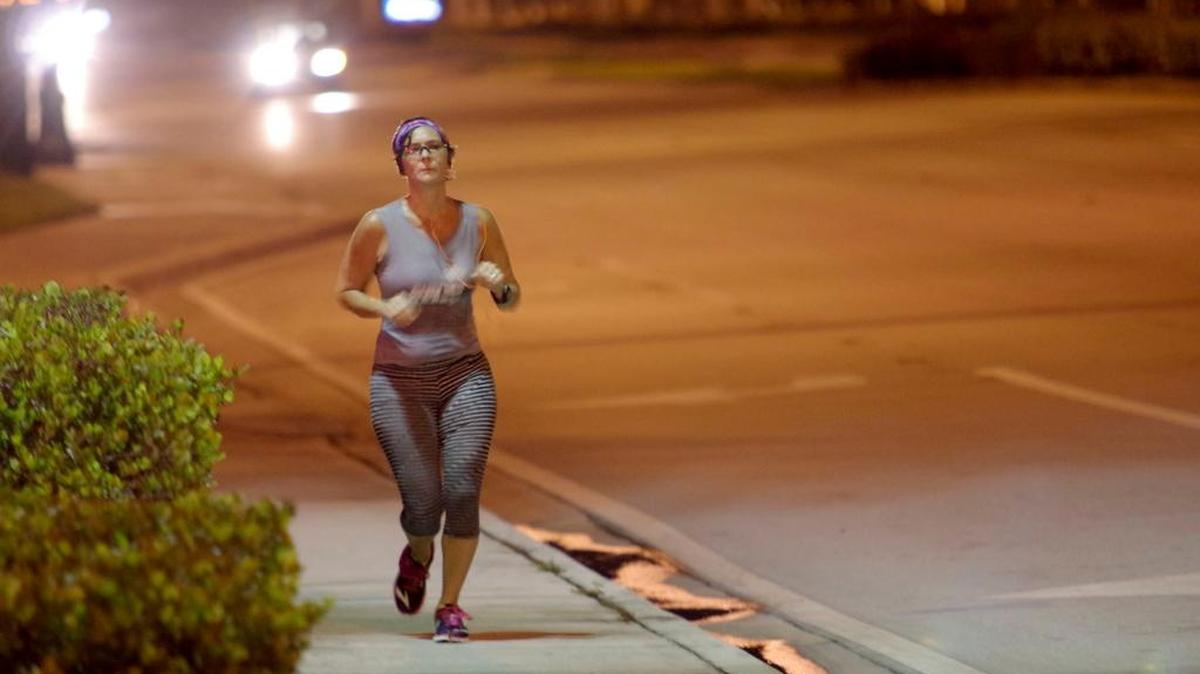 
Brittany Wallman runs south on State Road 7 during morning training for a half marathon in Plantation.
