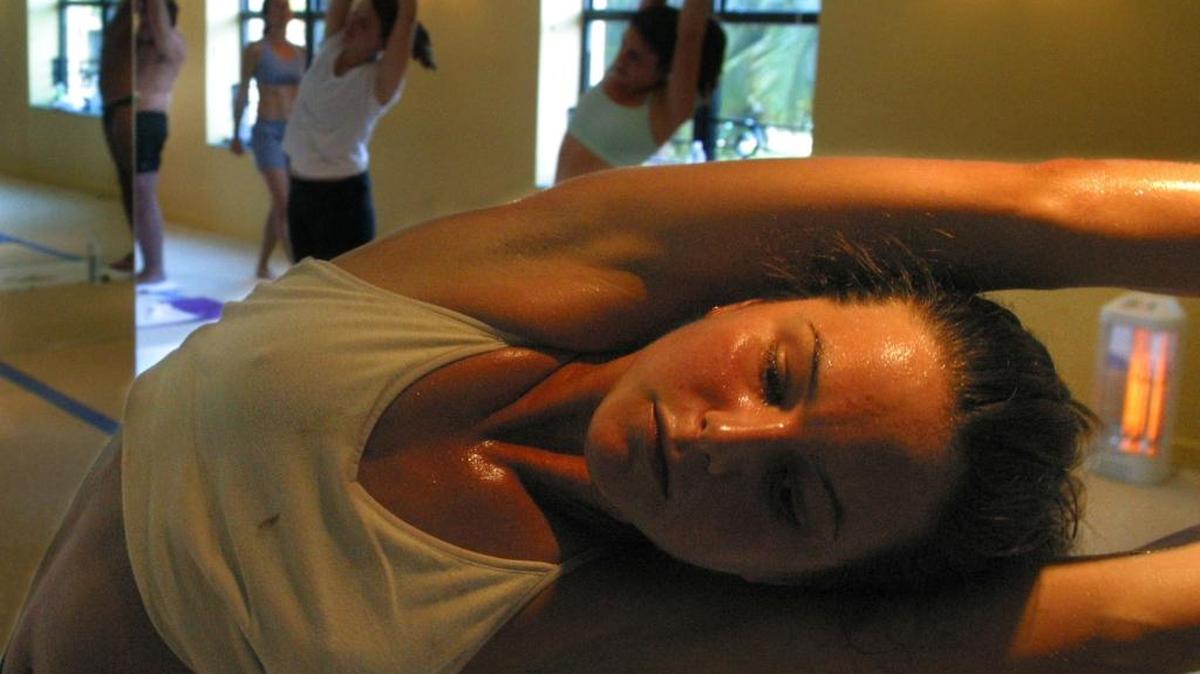 The Bikram Yoga of India has a school at the Netherland Hotel in Miami Beach, Bikram is a style of yoga done in a hot room to help cleans your body. Mariah Schuemann straches in a yoga exercise while the heater warms the room.
