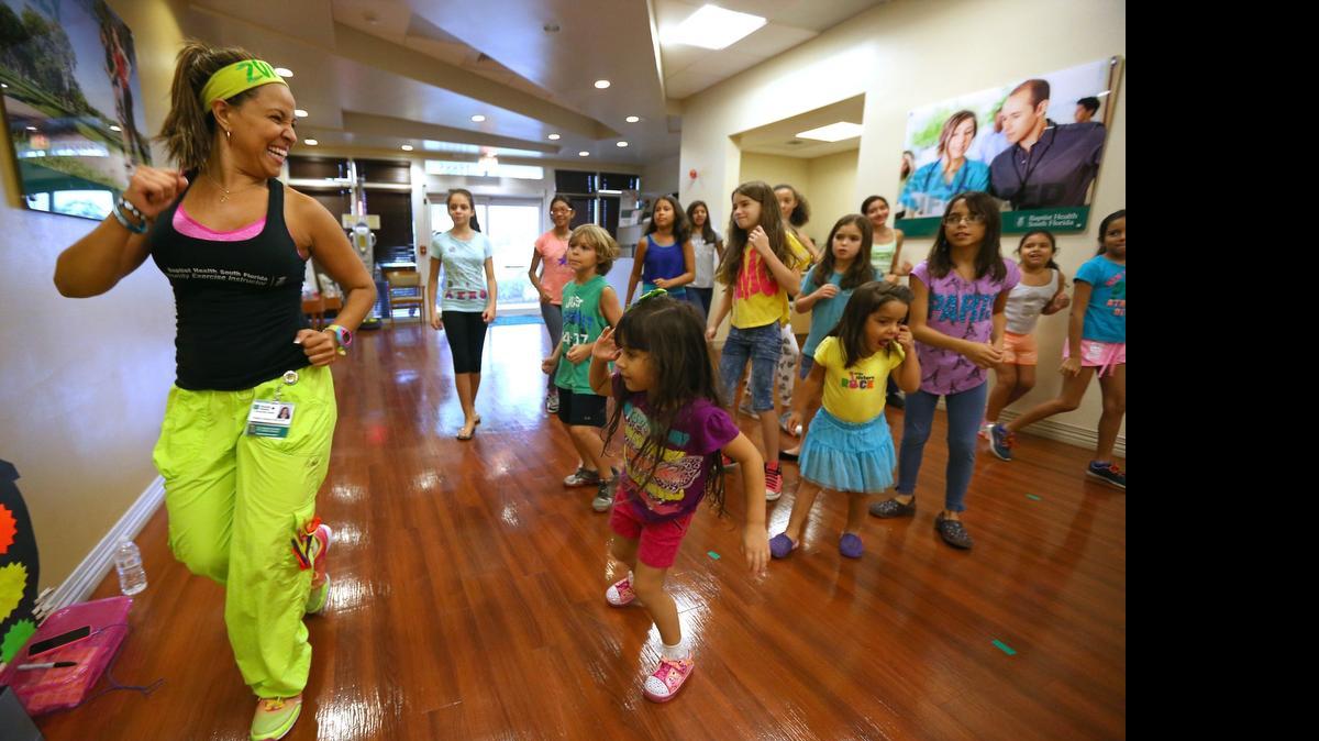
Zumba Instructor, Greysi E. Ospina, left, dances with their students during the Zumba class at Baptist Medical Plaza on Thursday, July 16, 2015 in Pembroke Pines. This is part of Baptist Health South Florida with new Healthy Living Centers programs available through hospitals and community centers.
