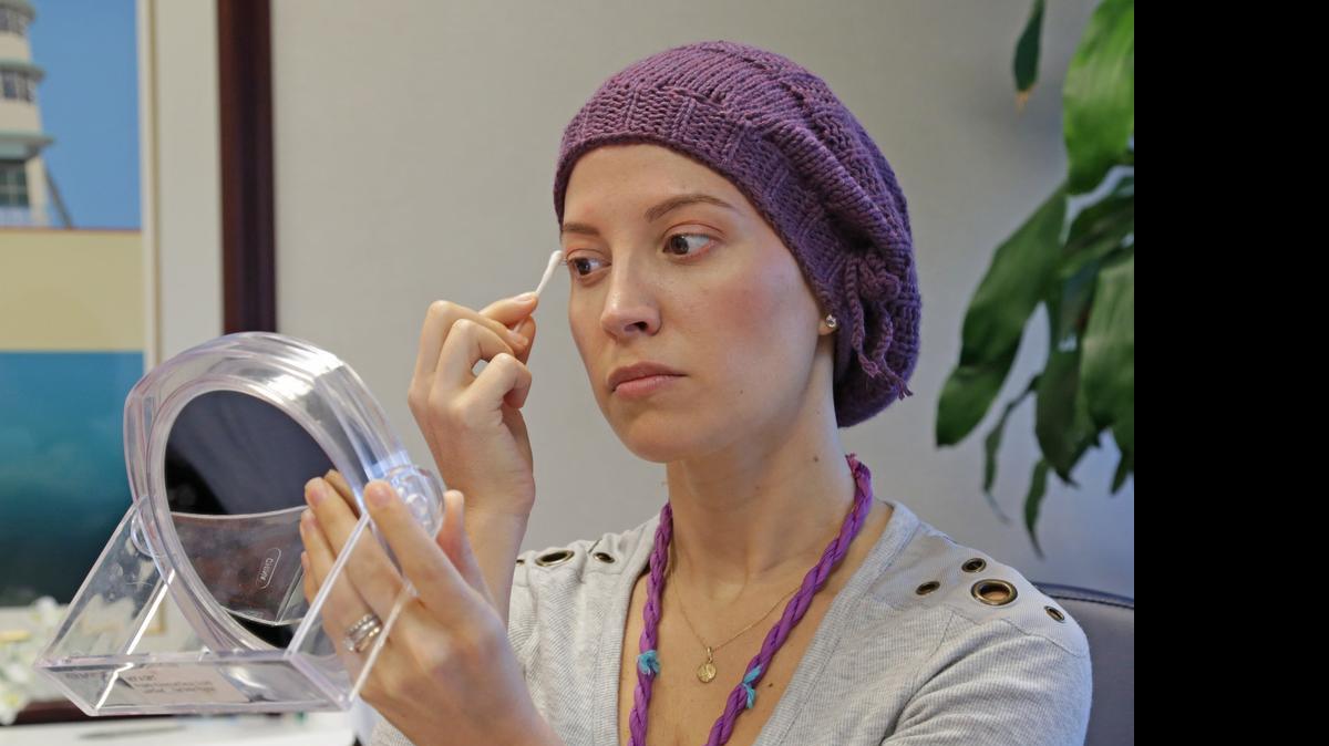 

Just a touch: Alexandra Phelan, 33, applies makeup during a ‘Look Good, Feel Better’ event hosted by the American Cancer Society at Mount Sinai Medical Center in Miami Beach on May 4. 

