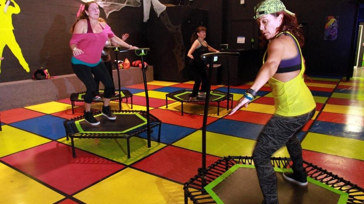 Eli Cedeno, right, leads a jumping fitness class; all the exercises are done on trampolines. The class is at Light 08 dance club and studio in West Kendall on Oct. 27, 2015.