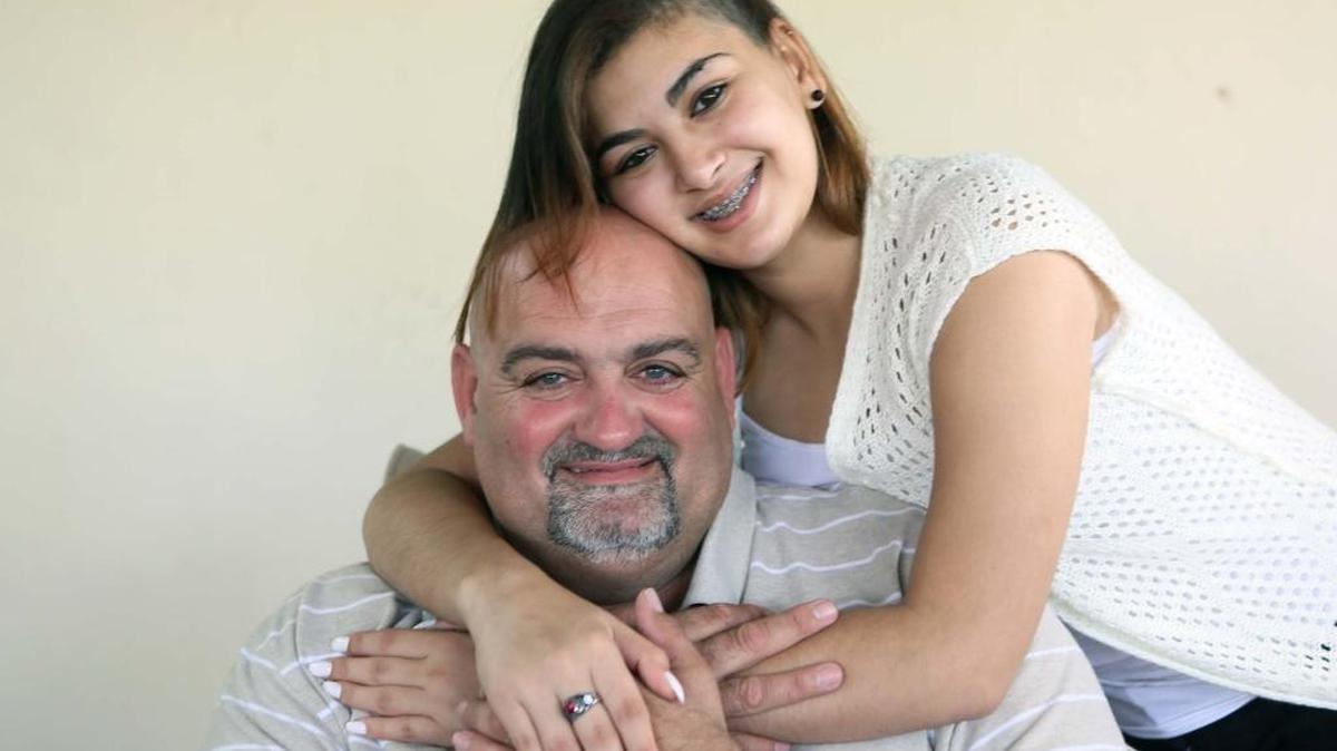 Ashley Santiesteban, 17, with her father, Juan Carlos Santiesteban, had a mass on her brain that was treated with a new imaging procedure at Baptist Hospital.