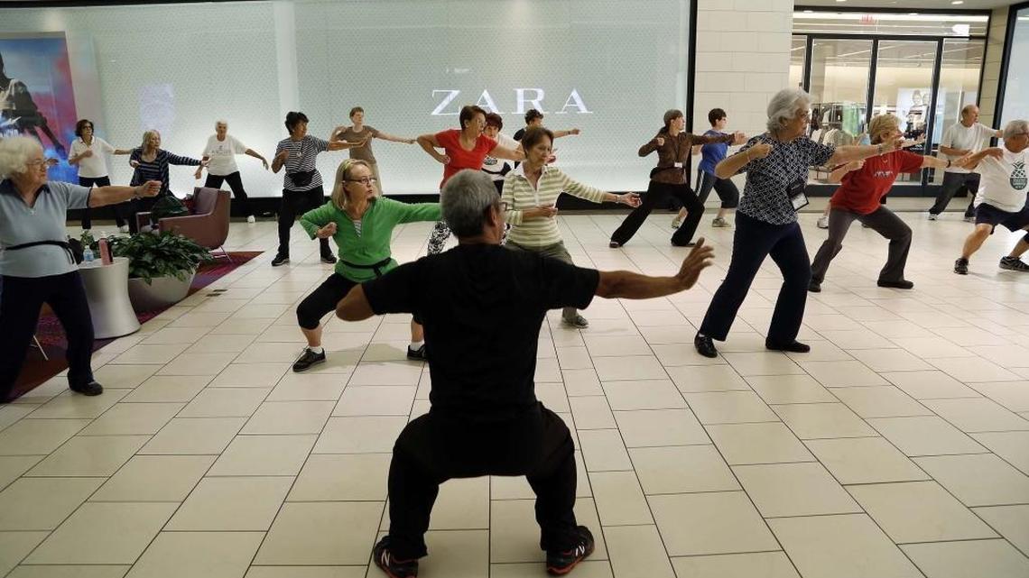 A group of seniors regularly walks at Dadeland Mall in the morning before it opens, as part of Baptist’s Mall Walkers program.Tai-Chi instructor Steve Chin leads the walkers on a warm-up beforehand.