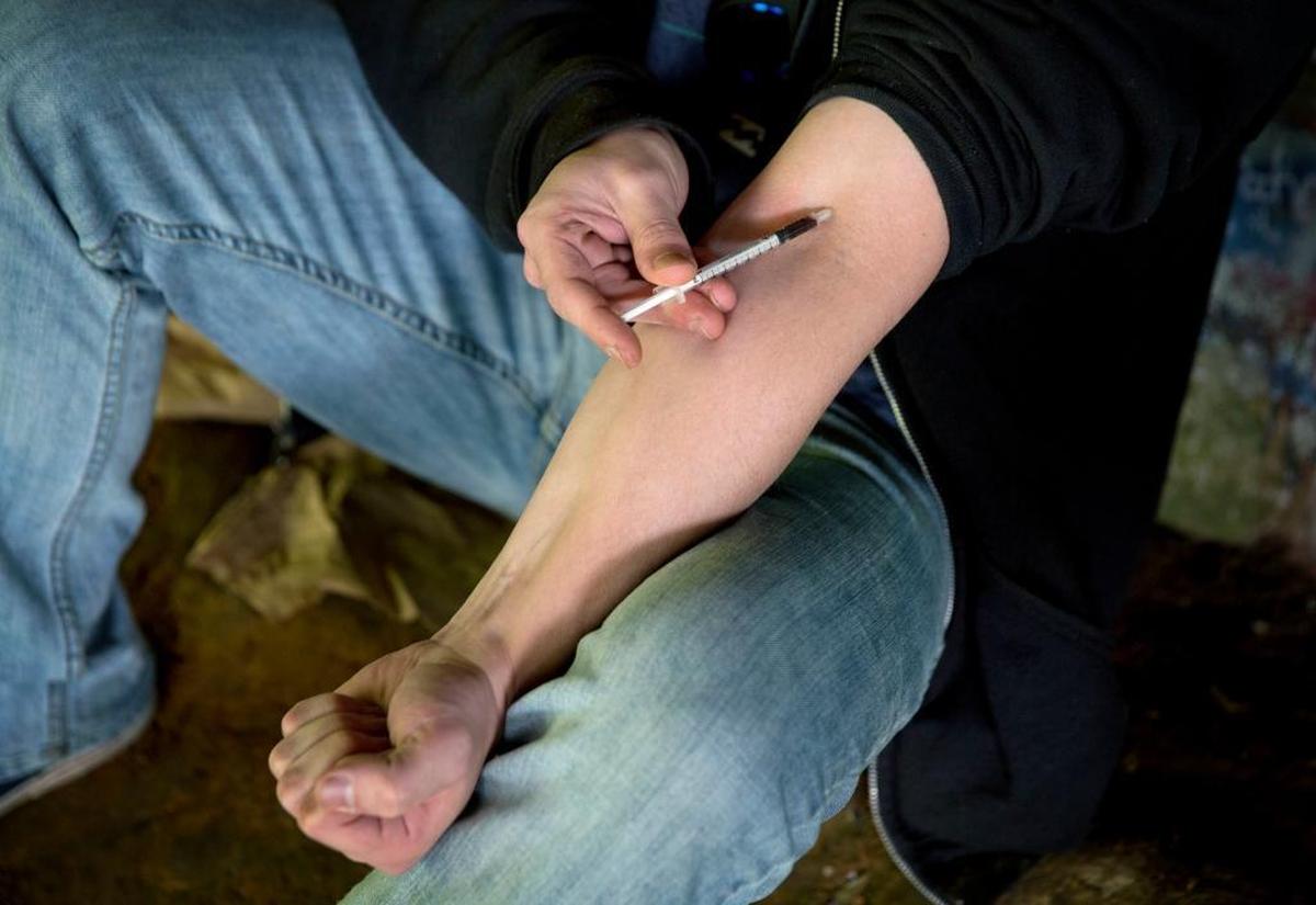 A user, age 24, injects heroin into this arm under a bridge along the Wishkah River at Kurt Cobain Memorial Park in Aberdeen, Wash., Tuesday, June 13, 2017.