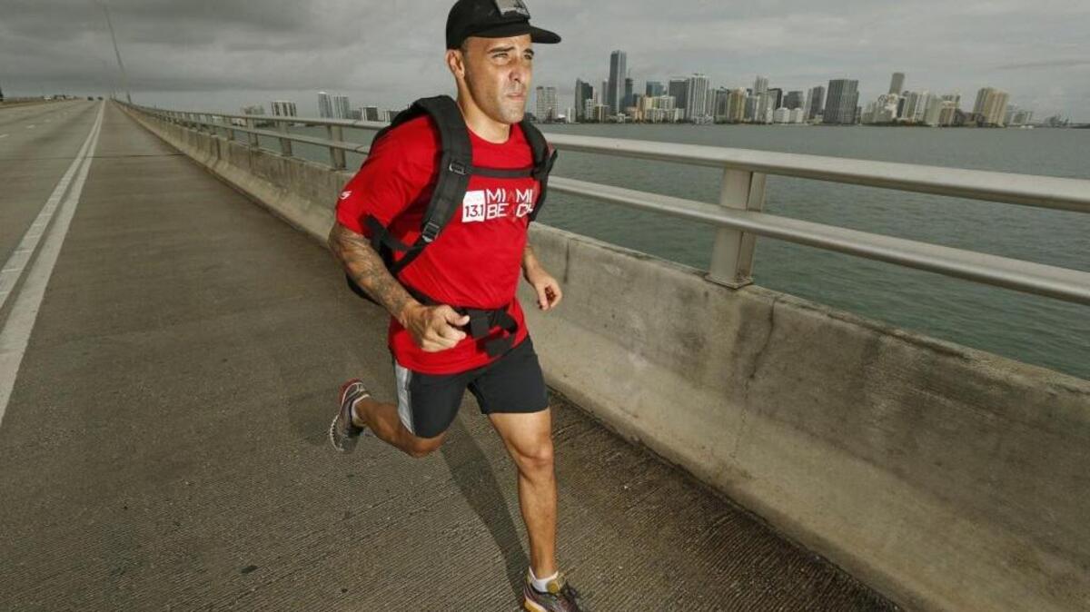 
Firefighter Gabe Arteaga runs along the Rickenbacker Causeway as he trains for a Navy SEALs challenge. He has recovered from ankle surgery on a severe break that normally would have meant his running days were over. 


