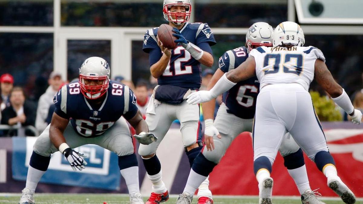 New England Patriots quarterback Tom Brady (12) takes the snap from a shotgun formation during the first half of an NFL football game against the Los Angeles Chargers on Sunday, Oct. 29, 2017, in Foxborough, Mass.