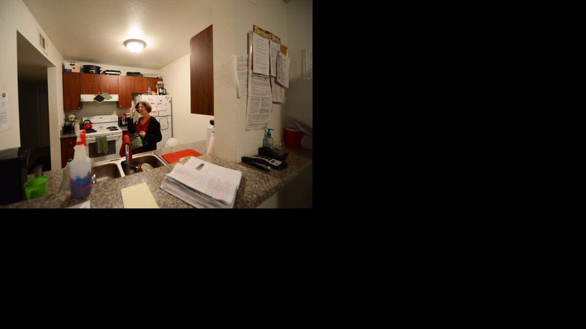 
Adele Elchert preps dinner and puts away her lunch box in her apartment kitchen in Gainesville, Fla. Elchert said she loves living in an apartment, and the independence that it gives her. She is being treated at the Arc of Alachua, a nonprofit organization that treats patients with Prader-Willi Syndrome, a genetic disorder in which people never feel full and have a voracious hunger.
