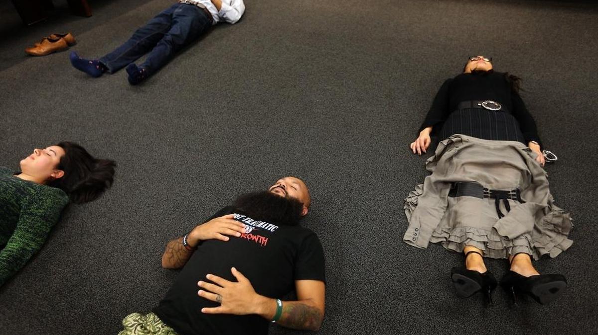 Veteran Hipolito Arriaga (center) lies down to meditate with the help of yoga and mindfuless trainer Molly Birkholm at the United Way of Miami Dade on Wednesday, October 19, 2016.