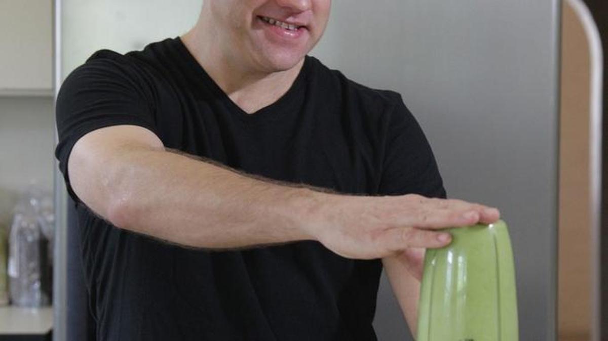 John Irvin prepares a veggie juice from mixed greens, cilantro, dill, ginger, lemon and water at his Little Havana home.